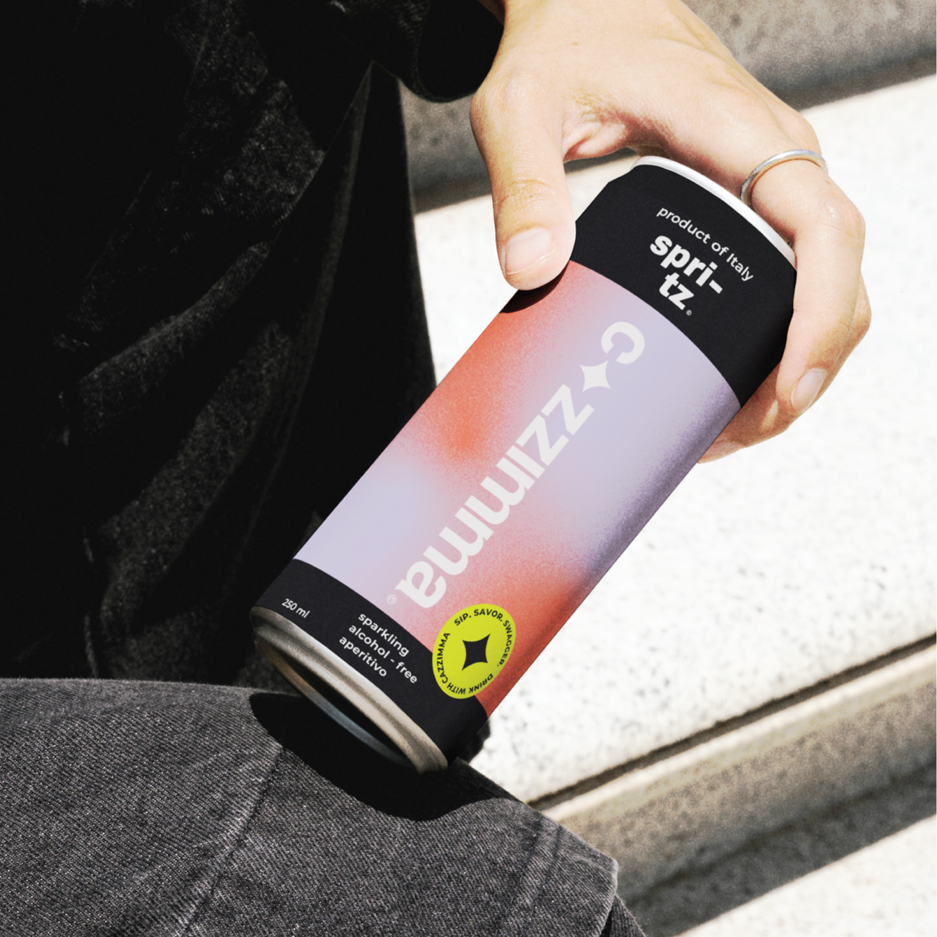 Person holding a can of cazzimma spritz.